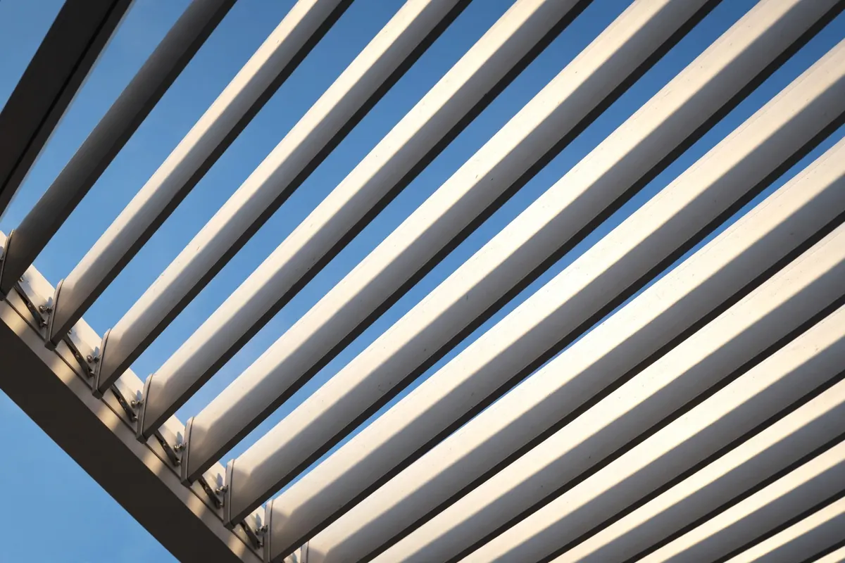 Close-up of pergola joinery and louvered shade lines